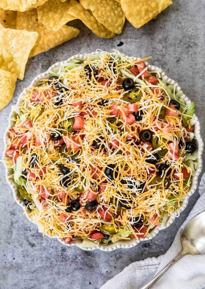 The BEST, easiest Taco Dip! This is so easy to make and so good! #tacodip #recipe #dip #cookout #summerfood Taco Dip in a pie dish