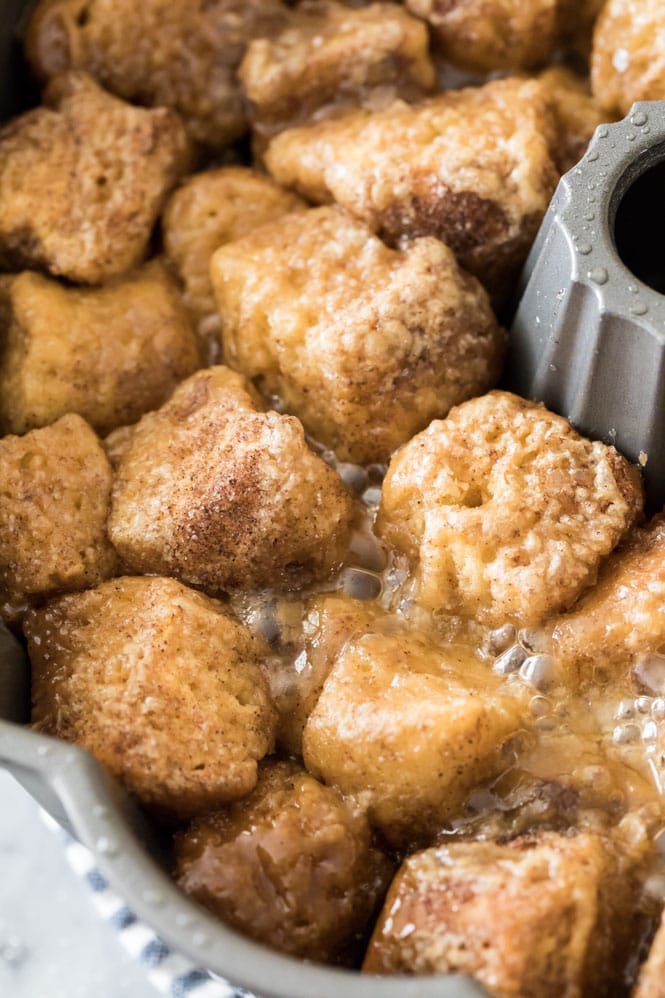 THE BEST Monkey Bread recipe! This homemade breakfast recipe is made completely from scratch, no yeast required! #monkeybread #breakfastrecipe #sugarspunrun Close-up shot of bubbly baked monkey bread in bundt pan