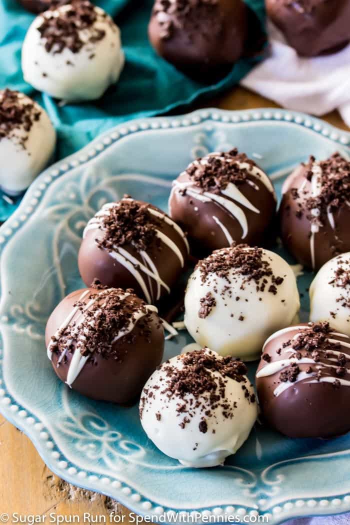 Just 4 ingredients for these easy OREO BALLS! An easy party dessert, ready in under 30 minutes! #sugarspunrun #oreoballs #oreotruffles #partyfood Oreo Truffles decorated with cookie crumbs on a blue plate