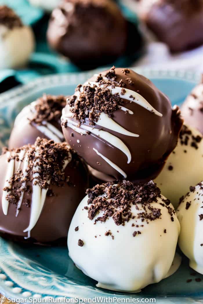 Just 4 ingredients for these easy OREO BALLS! An easy party dessert, ready in under 30 minutes! #sugarspunrun #oreoballs #oreotruffles #partyfood Chocolate Dipped Oreo Balls on a blue plate
