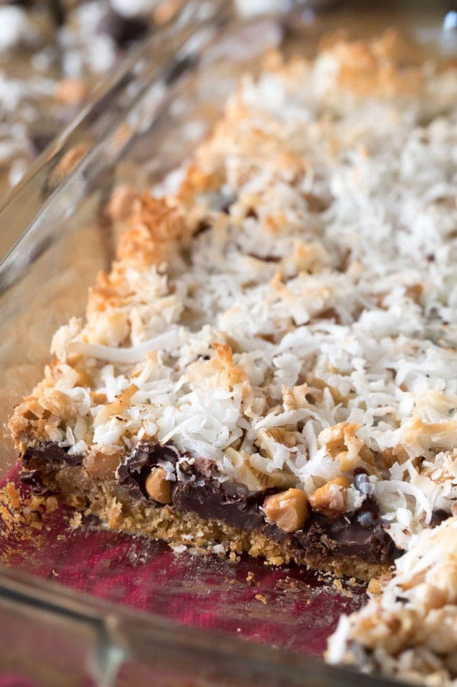 How to Make 7 Layer Bars! These are simple, 7-ingredient treats that everyone is sure to love! Magic Cookie Bars in a pan