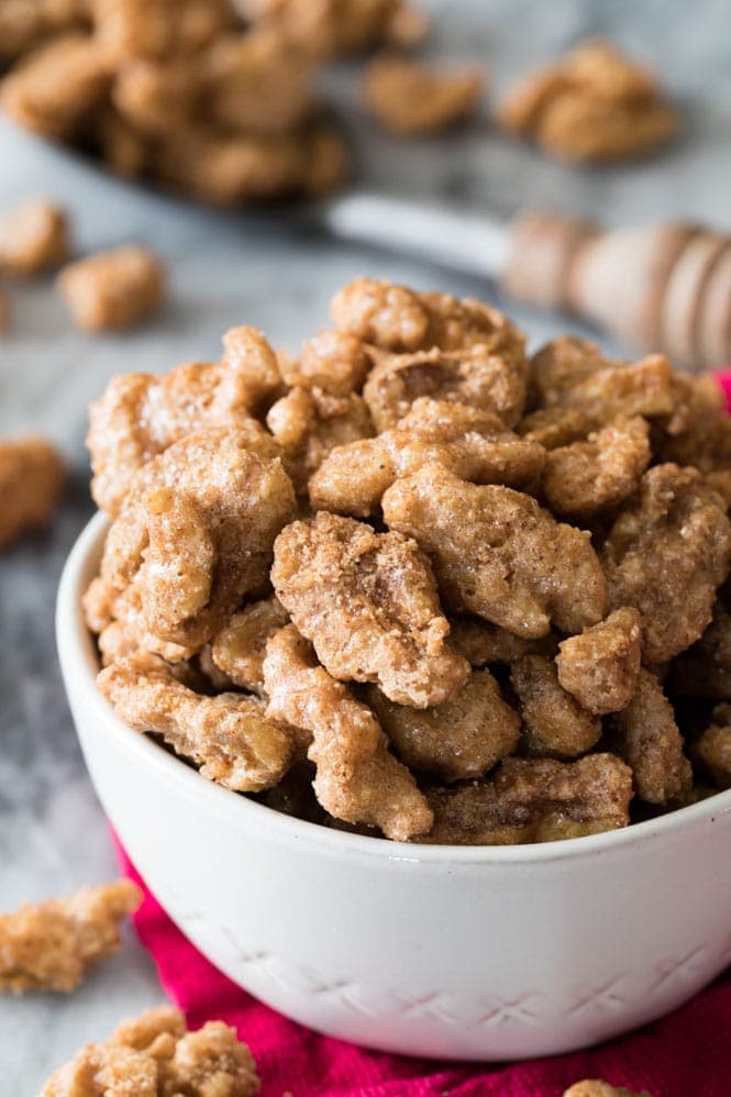 How to make Candied Walnuts -- These are SO GOOD!! #nuts #candiednuts #recipe #walnuts #dessert #baking #easyrecipe Candied Walnuts in a white bowl