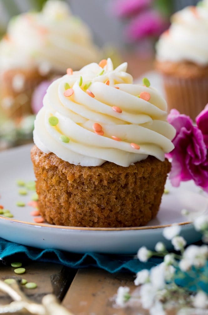 How to make the BEST Carrot Cake Cupcakes! #cupcake #carrotcake #recipe #dessert #creamcheese #easterdessert #easter #easterrecipe A Carrot Cake Cupcake Topped off with a cream cheese frosting swirl
