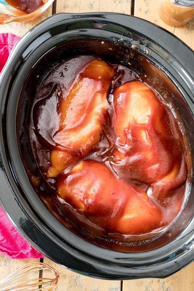 Easy BBQ Pulled Chicken -- made in the Crockpot Chicken breast in a barbecue marinade in the slow cooker