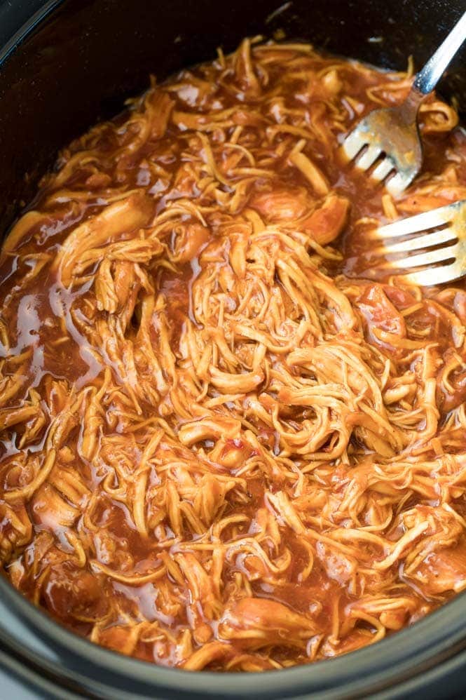 How to make Crock Pot BBQ Chicken! Pulled chicken in the basin of a slow cooker