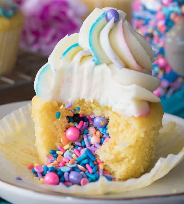 Piñata cupcake: topped with vanilla frosting, sprinkles pouring out of center