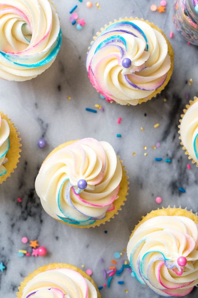 How to Make PINATA CUPCAKES! These are so fun and so easy to make! Overhead view of frosted pinata cupcakes