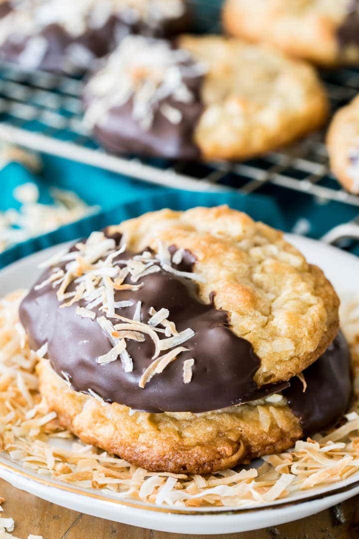 Buttery, chewy COCONUT COOKIES! These are so good! #cookies #coconut #recipe #baking #coconutcookies Two coconut cookies on a plate