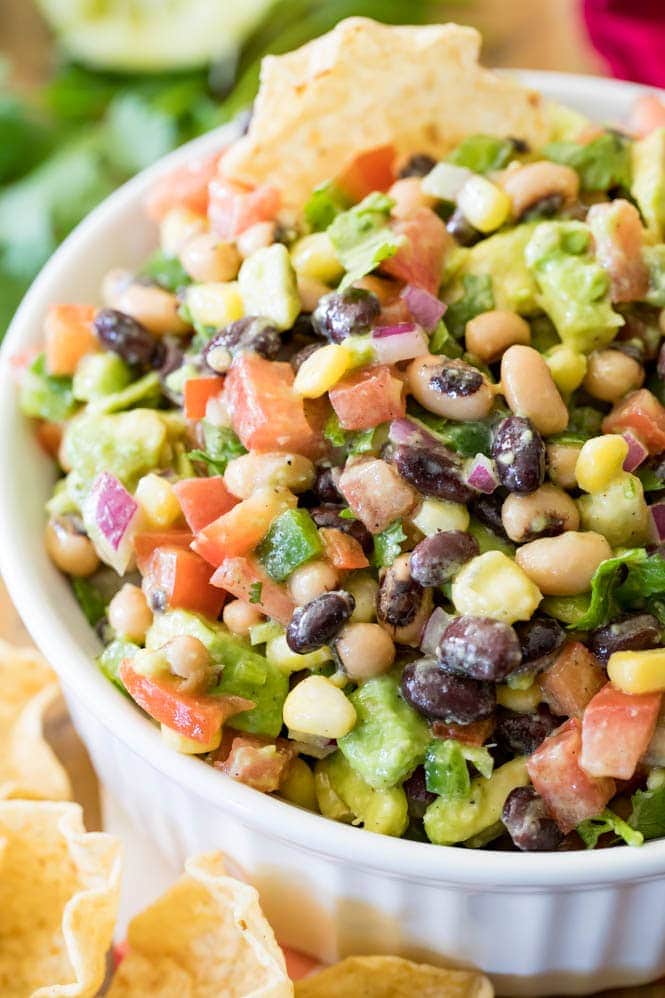 How to make TEXAS CAVIAR! Have you tried this summertime staple!? So good, everyone is going to want the recipe! #texascaviar #summersalad #dip #diprecipe #cookoutfood #partyfood #summerfood A white ramekin full of cowboy caviar