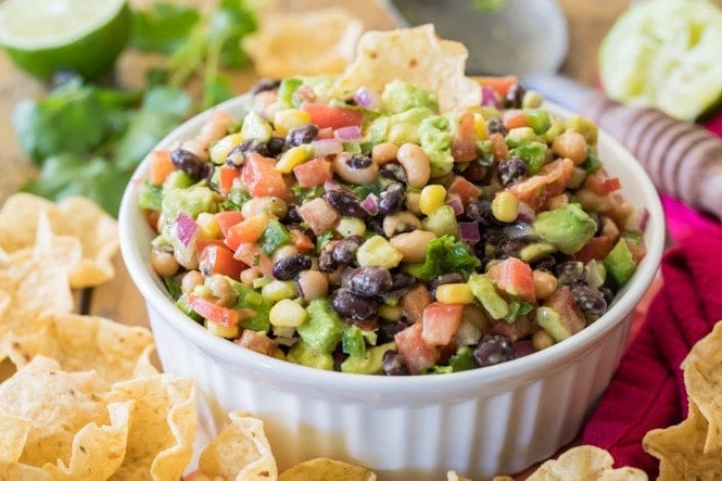 How to make TEXAS CAVIAR! Have you tried this summertime staple!? So good, everyone is going to want the recipe! #texascaviar #summersalad #dip #diprecipe #cookoutfood #partyfood #summerfood Texas Caviar and tortilla chips