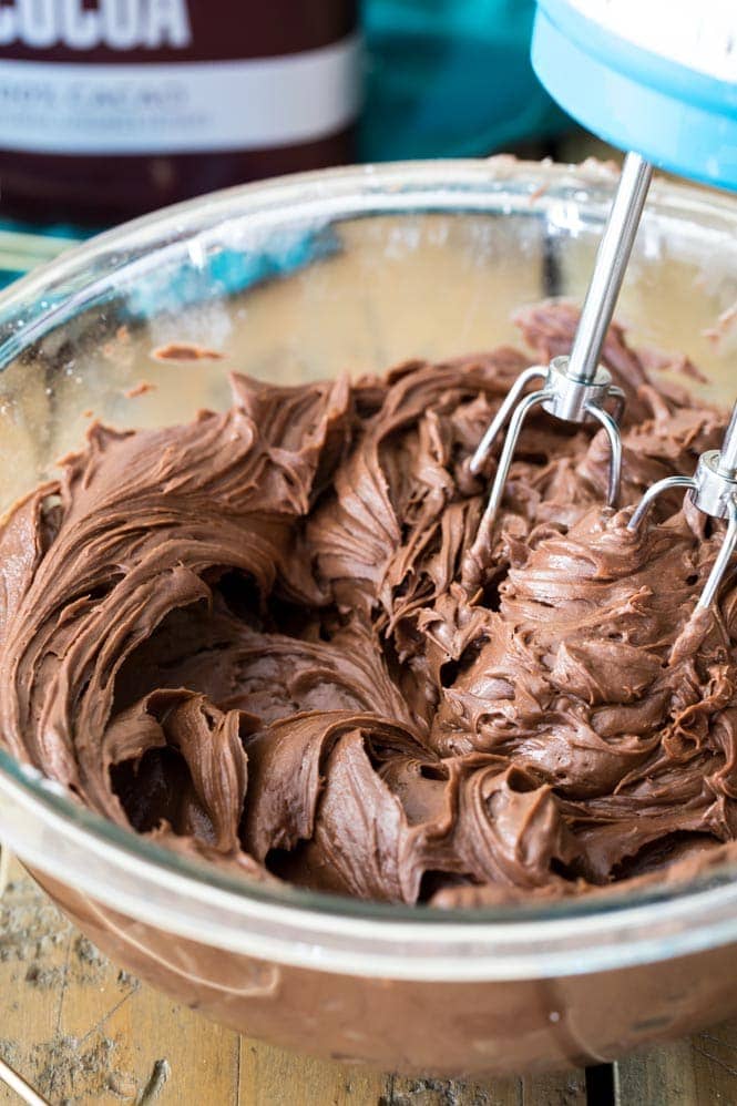 How to make Chocolate Cream Cheese Frosting! Smooth creamy, and perfect for piping, this is always a hit! #frosting #icing #chocolatefrosting #creamcheesefrosting #dessert #recipe creamy chocolate cream cheese frosting in a bowl