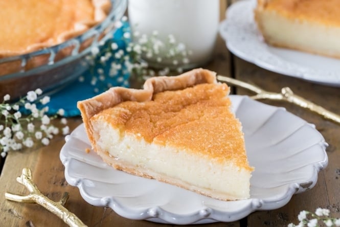 Have you ever tried BUTTERMILK PIE! A great old-fashioned recipe! #pie #thanksgivingpie Slice of buttermilk pie on white plate