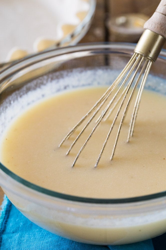 How to make BUTTERMILK PIE! Easy and an old-fashioned classic. #pierecipe #thanksgivingpie Whisking buttermilk pie filling