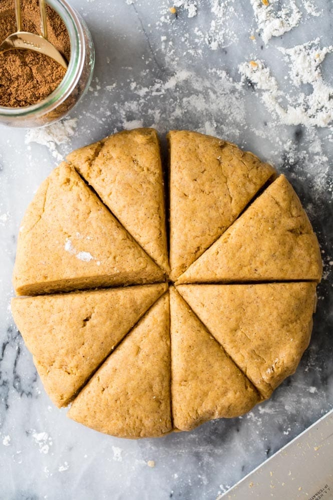 How to make the BEST Pumpkin Scones! These are so good! #fallbaking #pumpkinrecipe #scones #breakfast Making pumpkin scones: form the dough into disc and cut into wedges