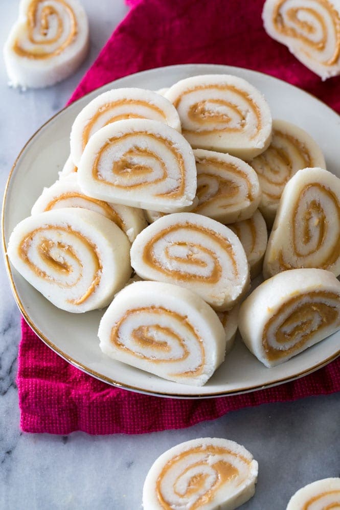 How to make POTATO CANDY! An old-fashioned favorite! #christmascandy #oldfashionedcandy sliced potato candy peanut butter pinwheels on a plate
