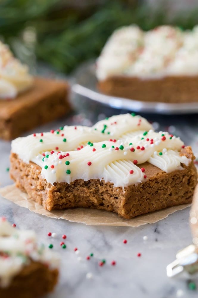 GINGERBREAD COOKIE BARS! Easier than cutting out cookies, and so soft and chewy and good! #gingerbreadcookies #christmasrecipe Soft and chewy Gingerbread Cookie bar with a bite out of it