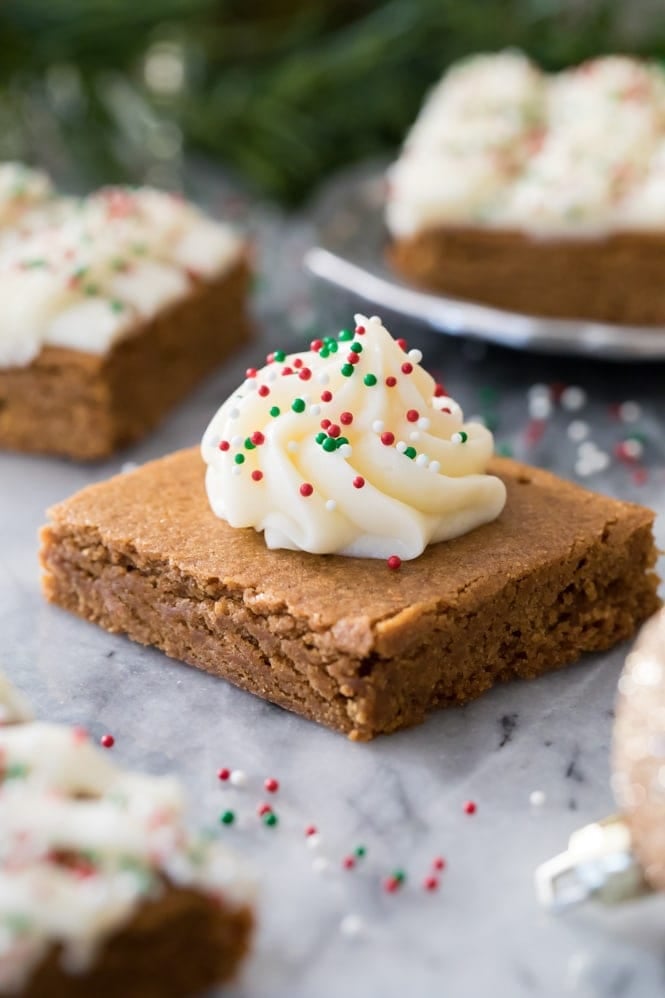 GINGERBREAD COOKIE BARS! Easier than cutting out cookies, and so soft and chewy and good! #gingerbreadcookies #christmasrecipe Gingerbread cookie bar square decorated with icing and sprinkles