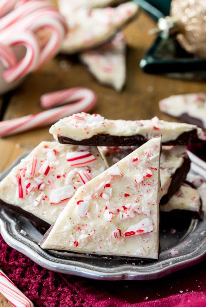 How to make an easy PEPPERMINT BARK at home! Super simple and SO good! #christmascandy #peppermintbark Plate of peppermint bark pieces