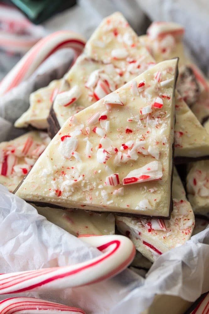 How to make an easy PEPPERMINT BARK at home! Super simple and SO good! #christmascandy #peppermintbark Peppermint bark pieces in a gift box