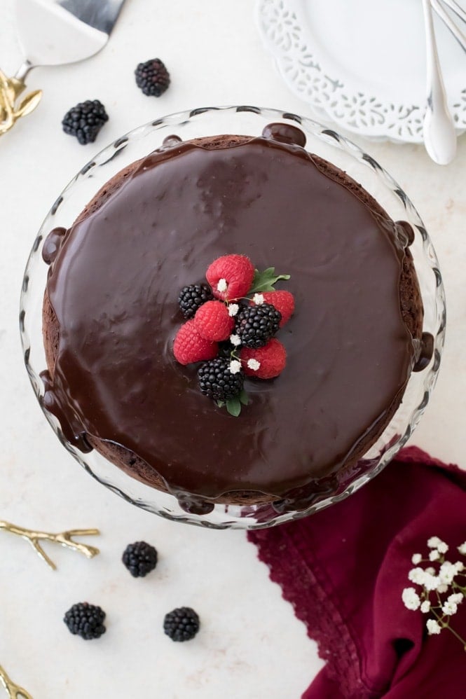 A rich, dense, & supremely fudgy FLOURLESS CHOCOLATE CAKE! #flourlesschocolatecake #glutenfree Ganache poured over flourless chocolate cake