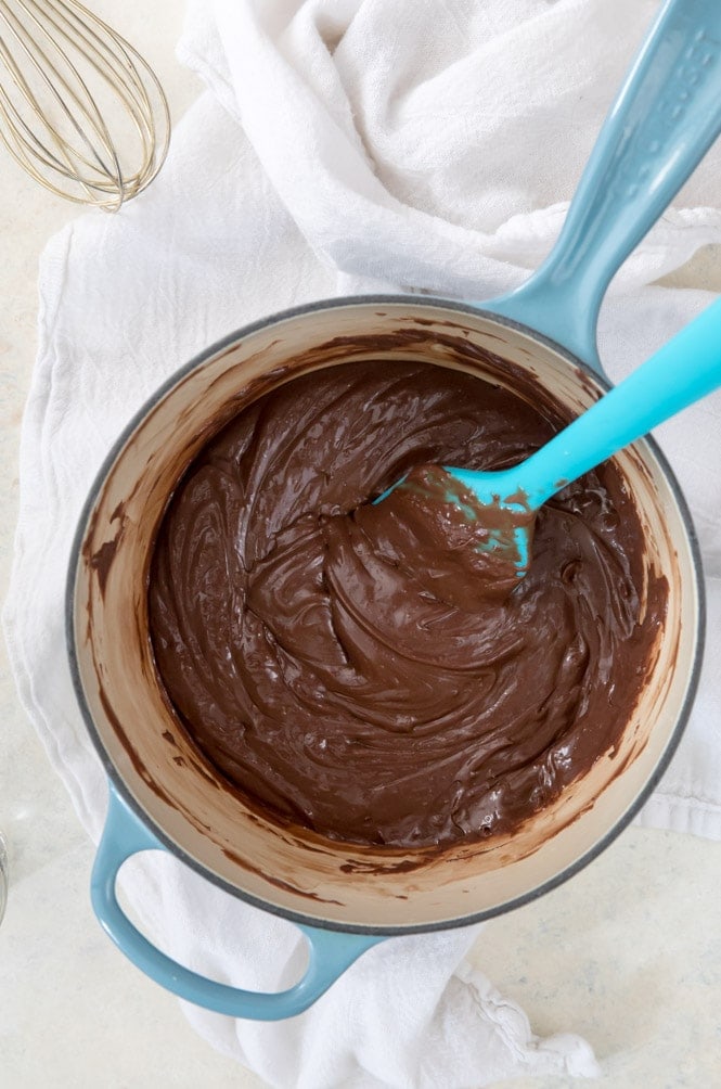 The best EASY Fudge Recipe! It makes the best fudge! #candyrecipe #fudgerecipe Melting together all ingredients for easy fudge in saucepan