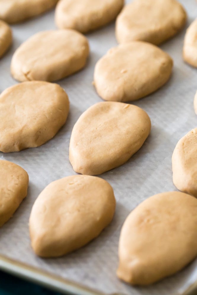 How to make homemade PEANUT BUTTER EGGS! The perfect Easter treat! #peanutbuttereggs #easterrecipe Peanut Butter Eggs after being rolled out on baking sheet