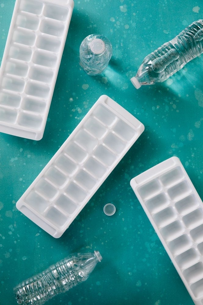 HOW TO MAKE ICE! How did I not think of this! #icerecipe #bestrecipe Overhead view of ice cube trays and water bottles