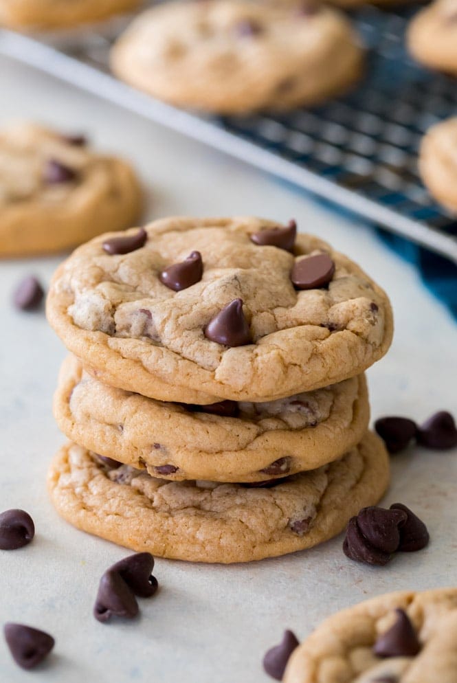 PUDDING COOKIES! This is the softest, chewiest cookie recipe you'll ever try! #cookierecipe #puddingcookies #sugarspunrun Stack of pudding cookies beside cooling rack