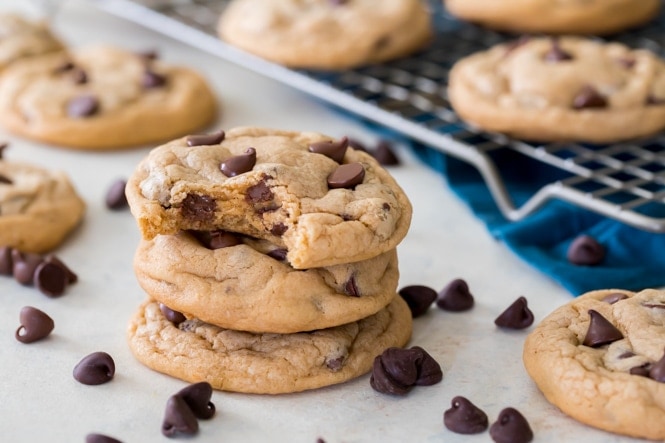 PUDDING COOKIES! This is the softest, chewiest cookie recipe you'll ever try! #cookierecipe #puddingcookies #sugarspunrun Pudding cookies with bite out of it, showing soft interior