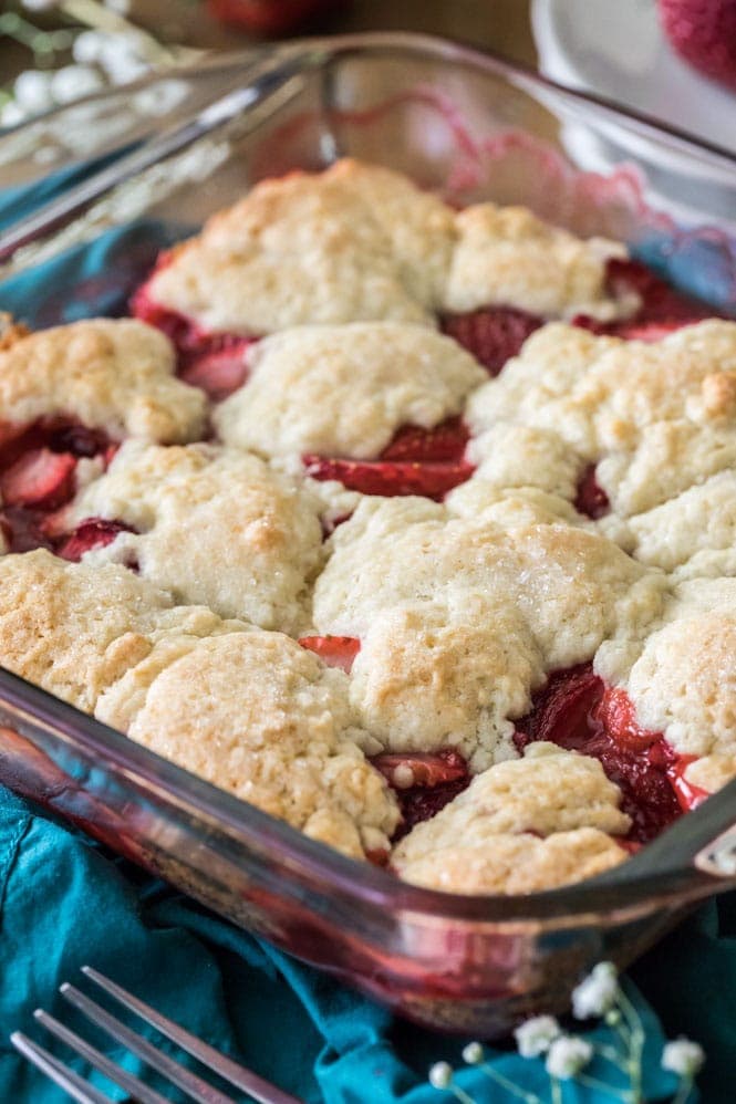 How to make a sweet and simple STRAWBERRY COBBLER! Easy and made completely from scratch, this recipe is a great way to use up summertime berries! #strawberryrecipe #cobblerrecipe #sugarspunrun #summerbaking Strawberry cobbler baked in glass baking dish