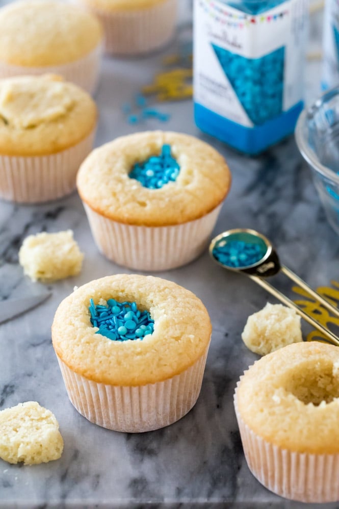 A sweet and simple recipe for Gender Reveal Cupcakes! Fill them with either pink or blue sprinkles for a fun surprise reveal #genderreveal #genderrevealcupcakes #genderrevealcake #babyshower #sugarspunrun How to make gender reveal cupcakes: filling cupcakes with sprinkles