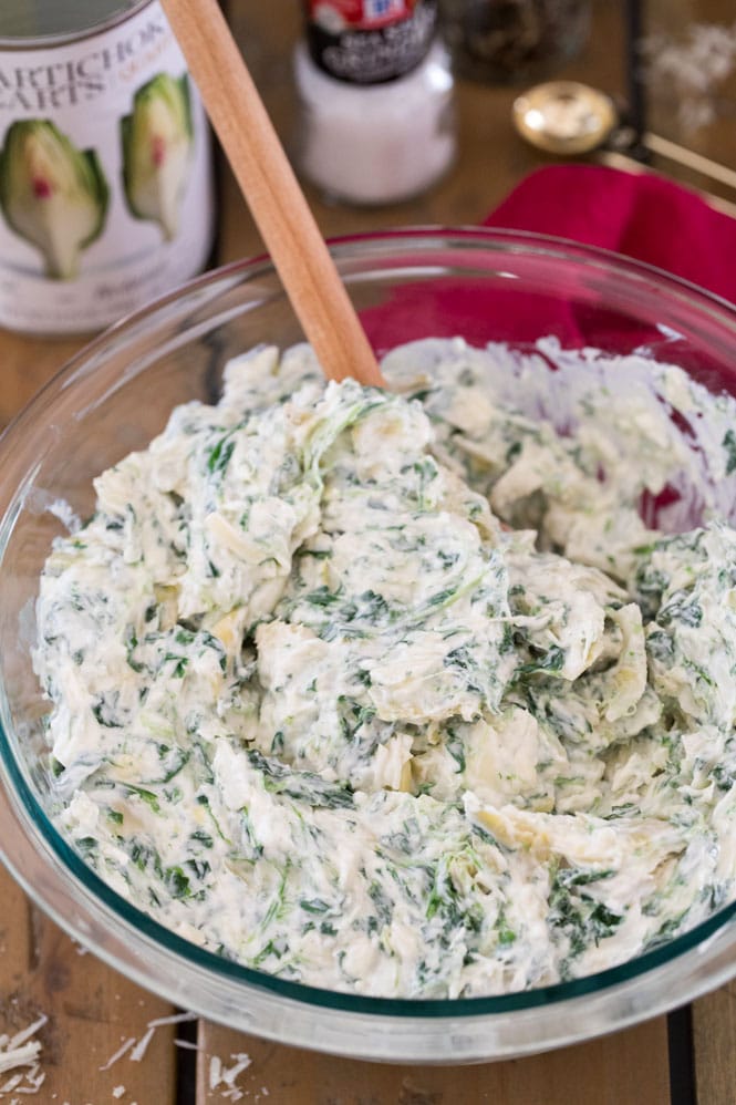 How to make the BEST Spinach Artichoke Dip! This is a creamy, easy, cheesy recipe! #sugarspunrun #spinachartichokedip #potluckrecipe Spinach artichoke dip ingredients mixed together in bowl