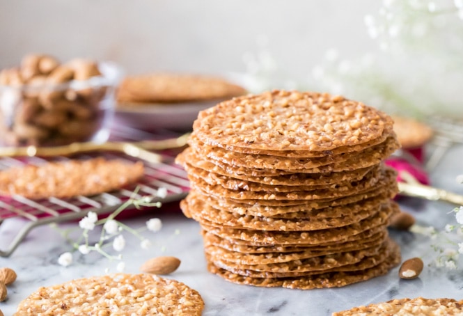 Lace cookies stacked on marble surface