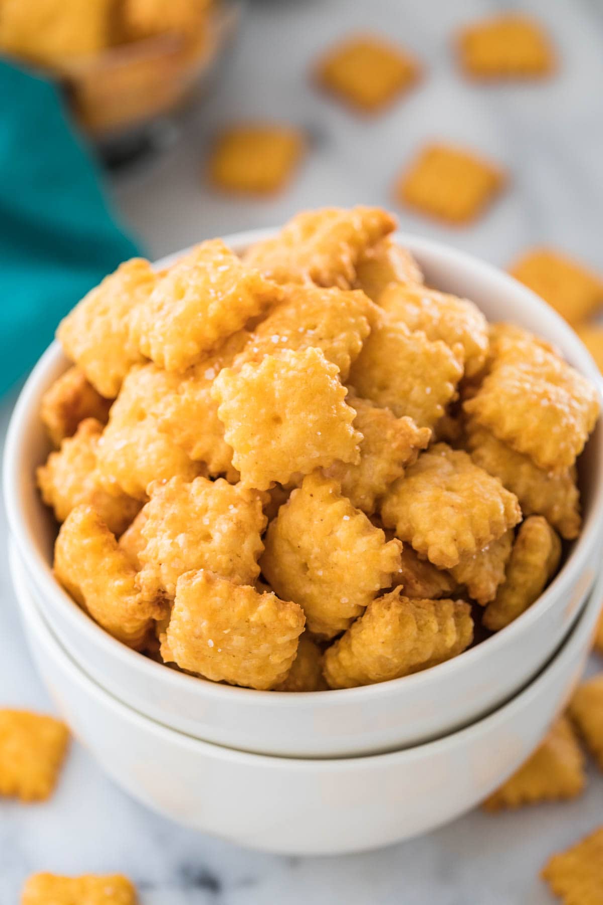 Close-up view of homemade cheese crackers in stacked white bowls