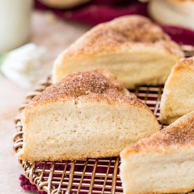 Cinnamon sugar dusted snickerdoodle scones on gold cooling rack