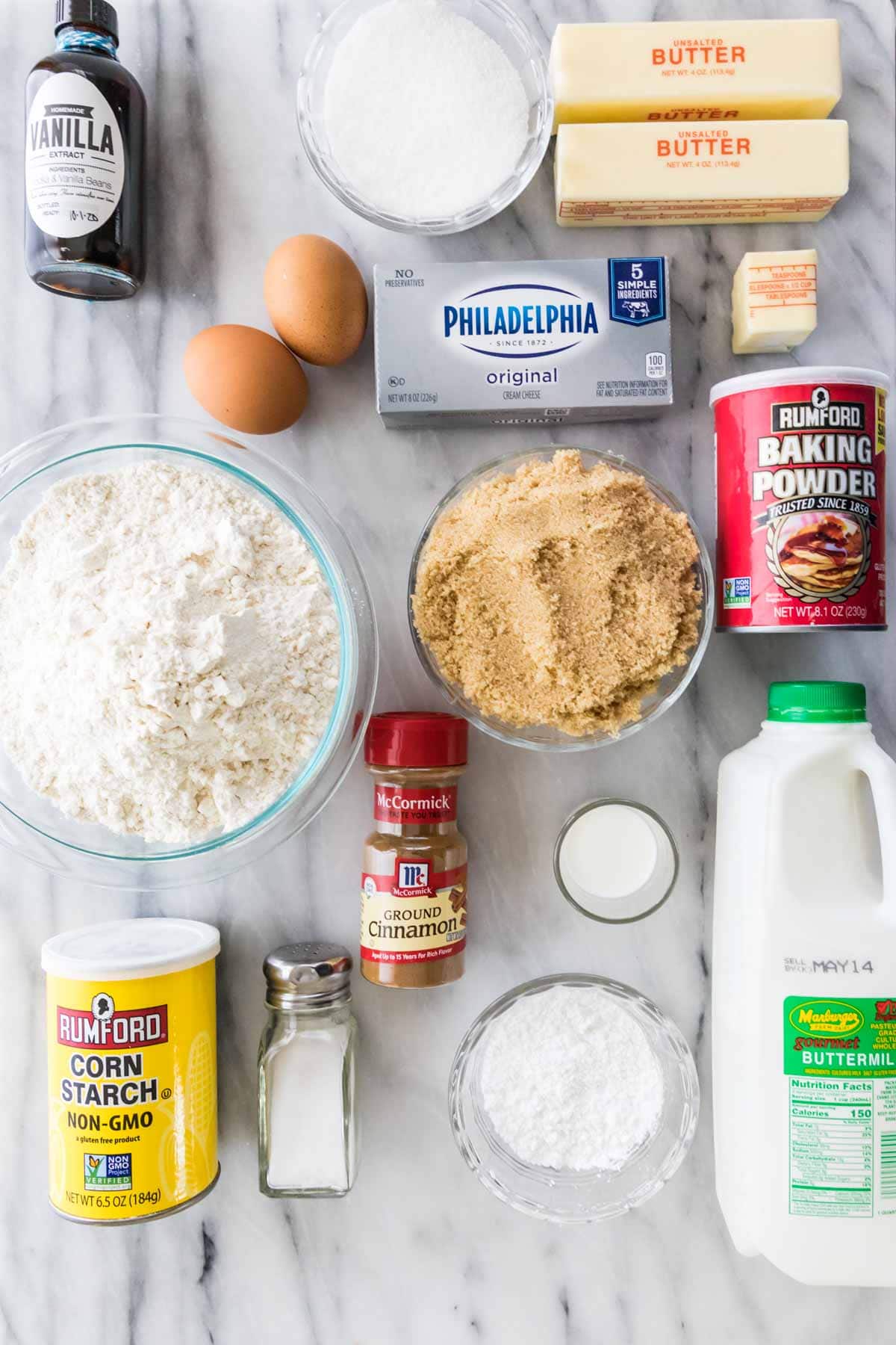 overhead view of ingredients for cinnamon coffee cake including flour, sugar, buttermilk, cinnamon, and more