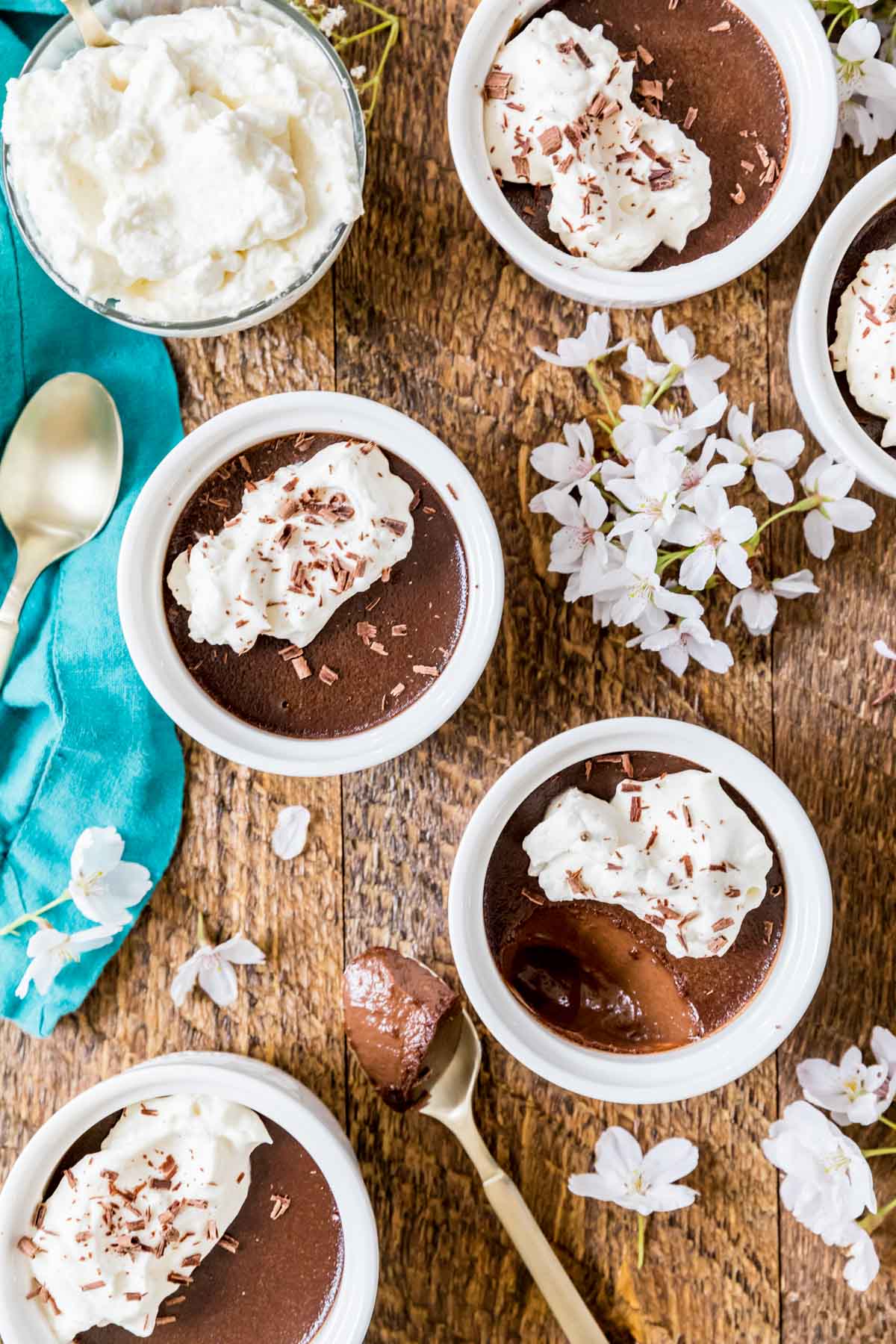 Overhead view of chocolate pot de creme in small white ramekins.