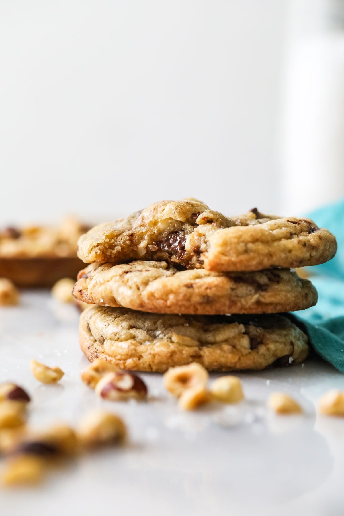 Three stacked hazelnut chocolate chip cookies.