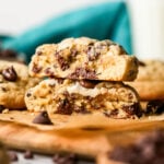 Two halves of thick chocolate chip cookies stacked on top of each other.