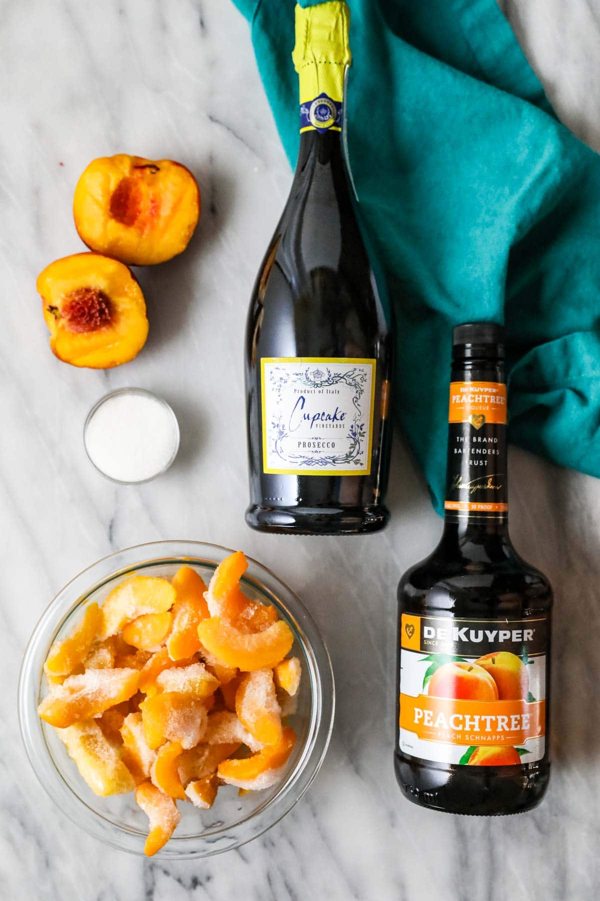 Overhead view of ingredients including frozen peaches, peach schnapps, and  more.