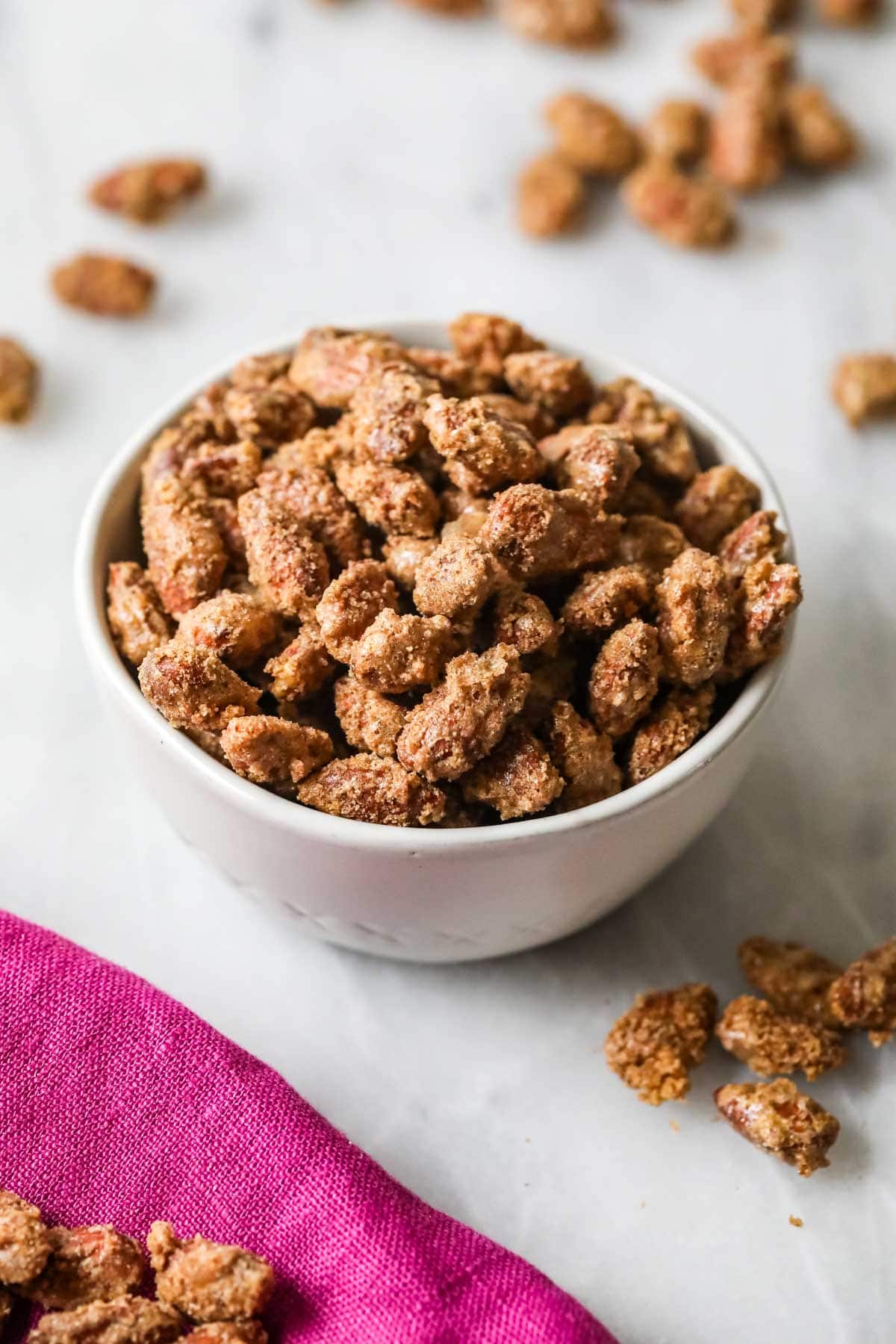 Cinnamon sugar roasted almonds in a white bowl.