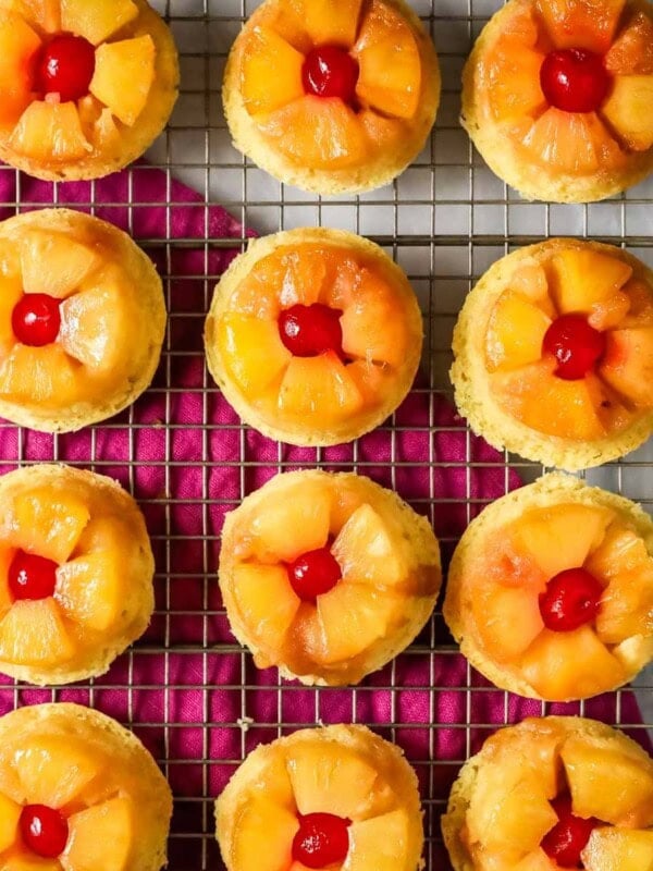 Overhead view of pineapple upside down cupcakes on a cooling rack.