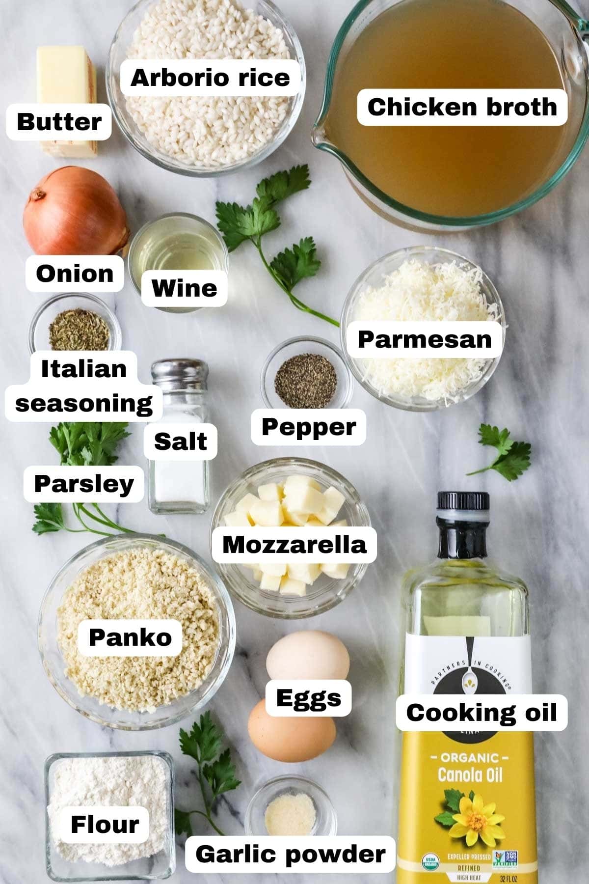 Overhead view of labelled ingredients including panko bread crumbs, arborio rice, cheese, and more.