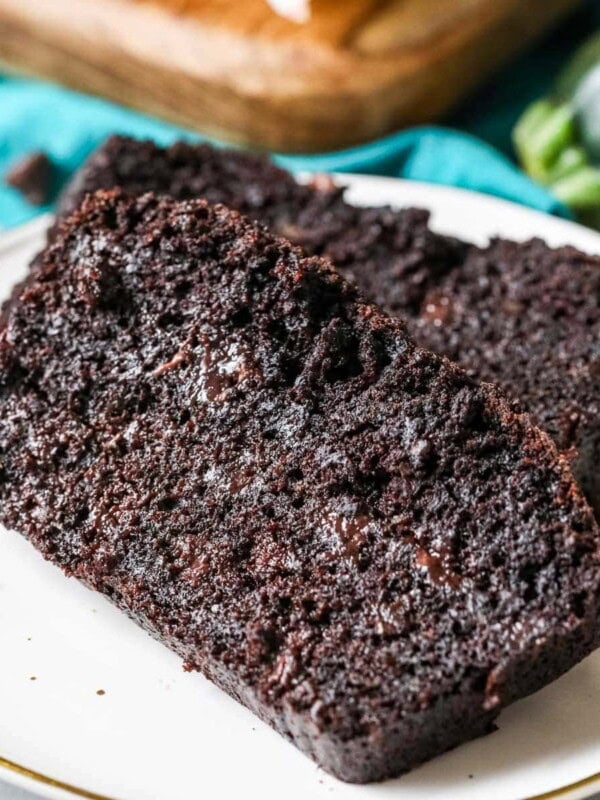Two slices of chocolate zucchini bread on a plate.