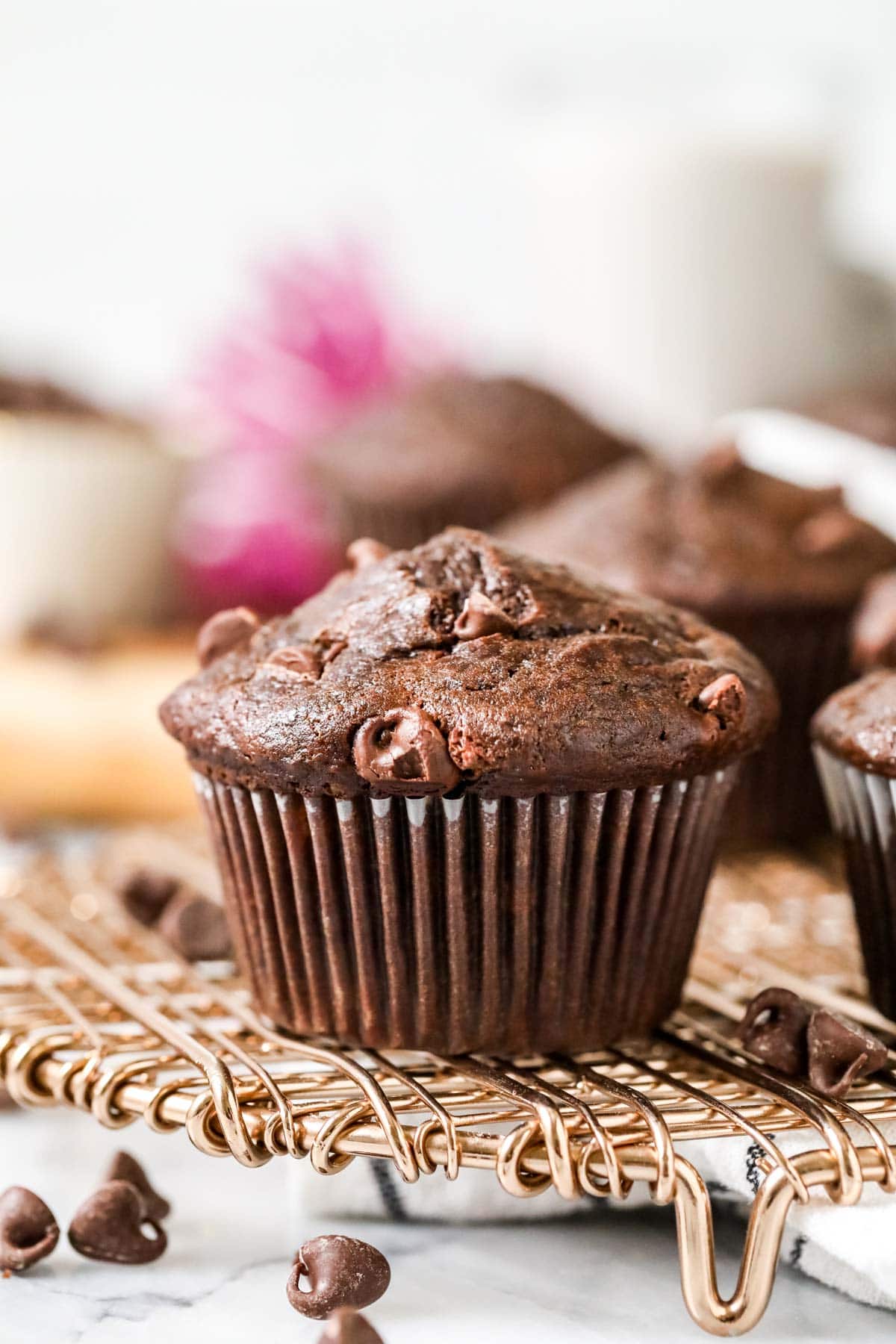 Chocolate muffin made with banana on a cooling rack.