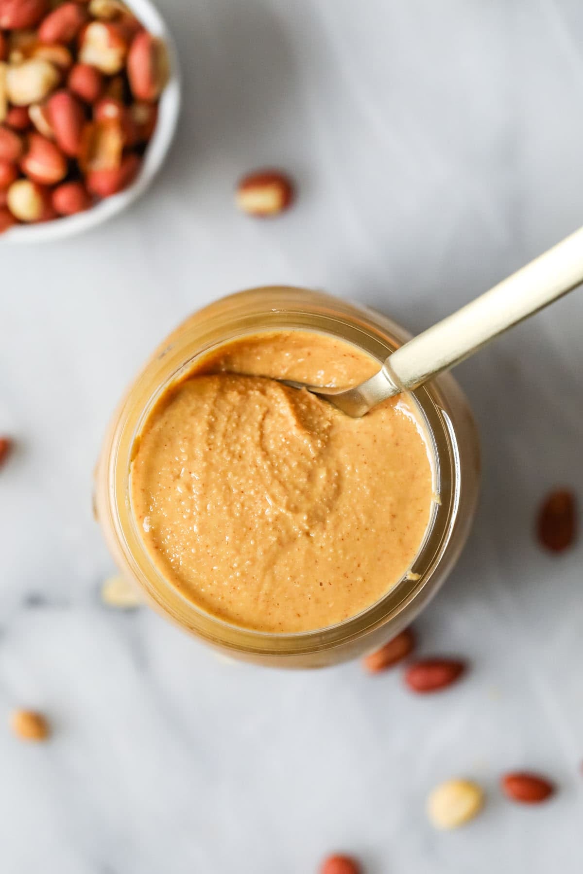 Overhead view of a jar of homemade peanut butter.