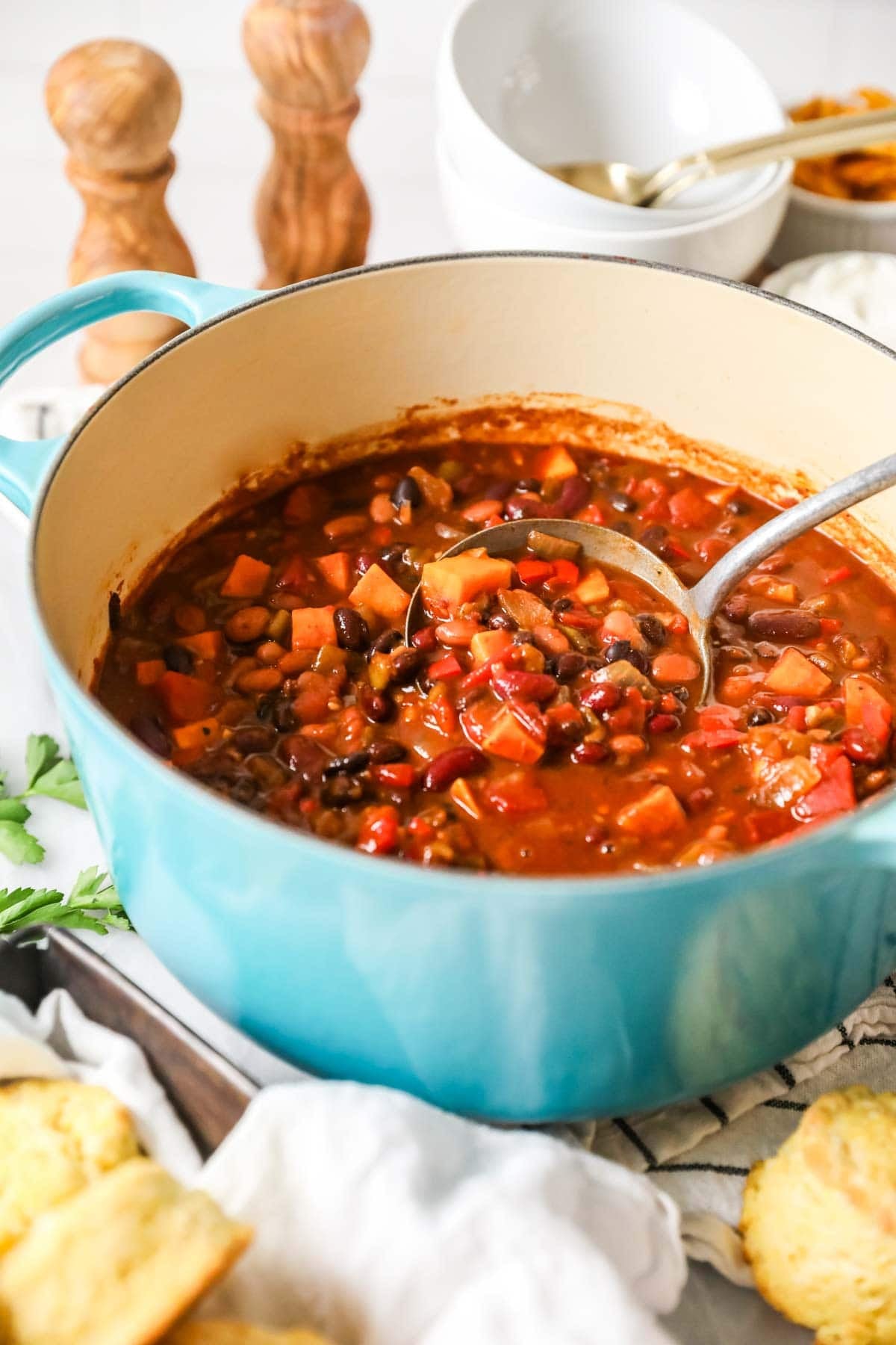 Pot of vegetarian chili made with sweet potato, beans, and more.