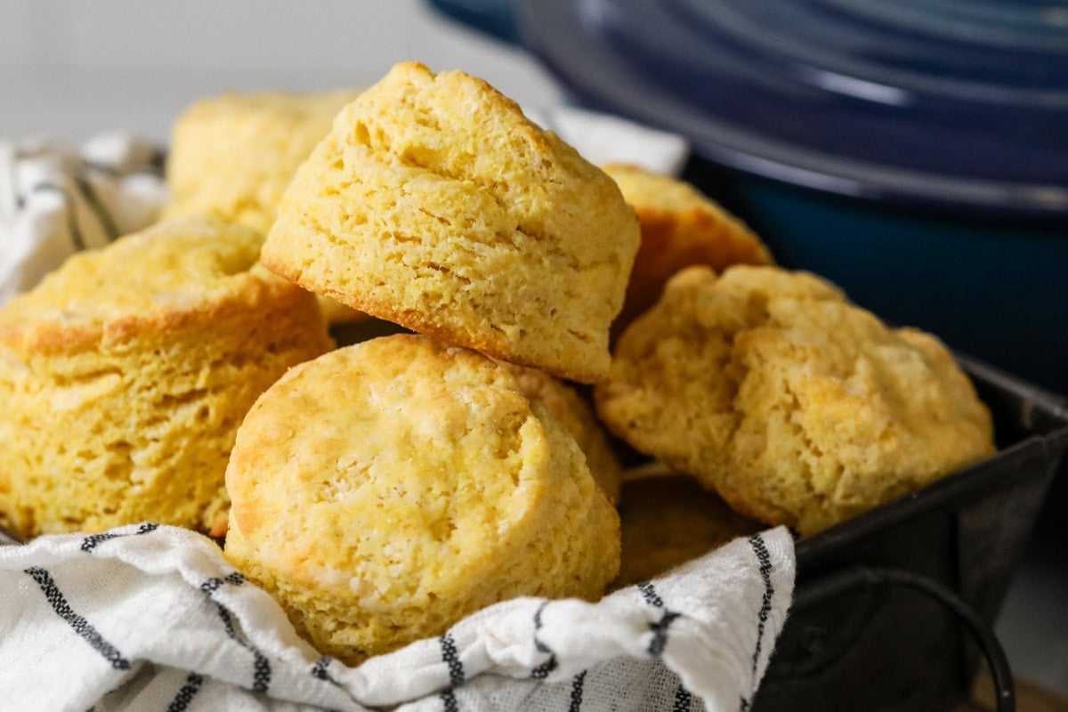 Tall cornbread biscuits with flaky layers in a pile.