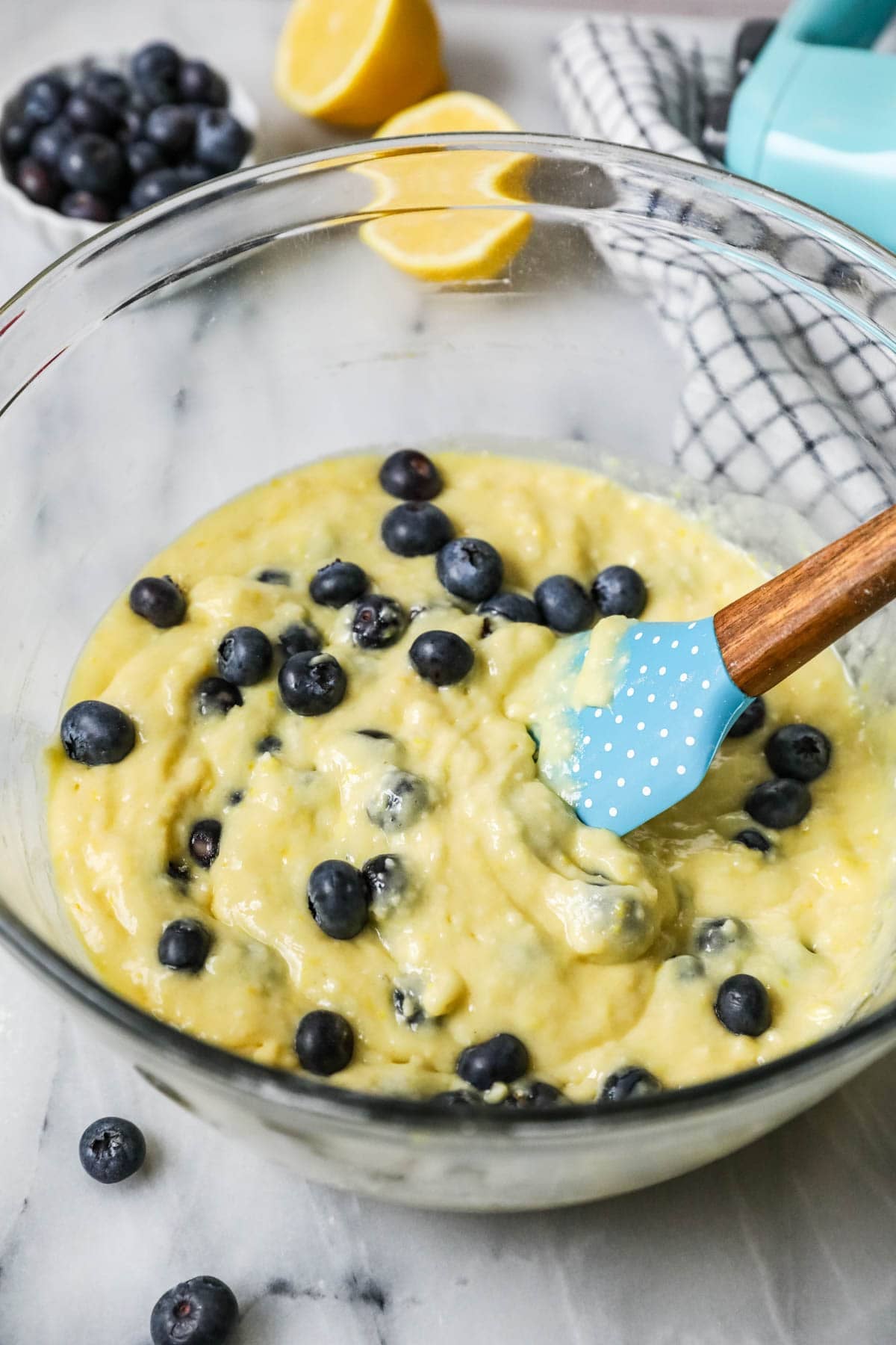 Blueberries being stirred into a lemon cupcake batter.