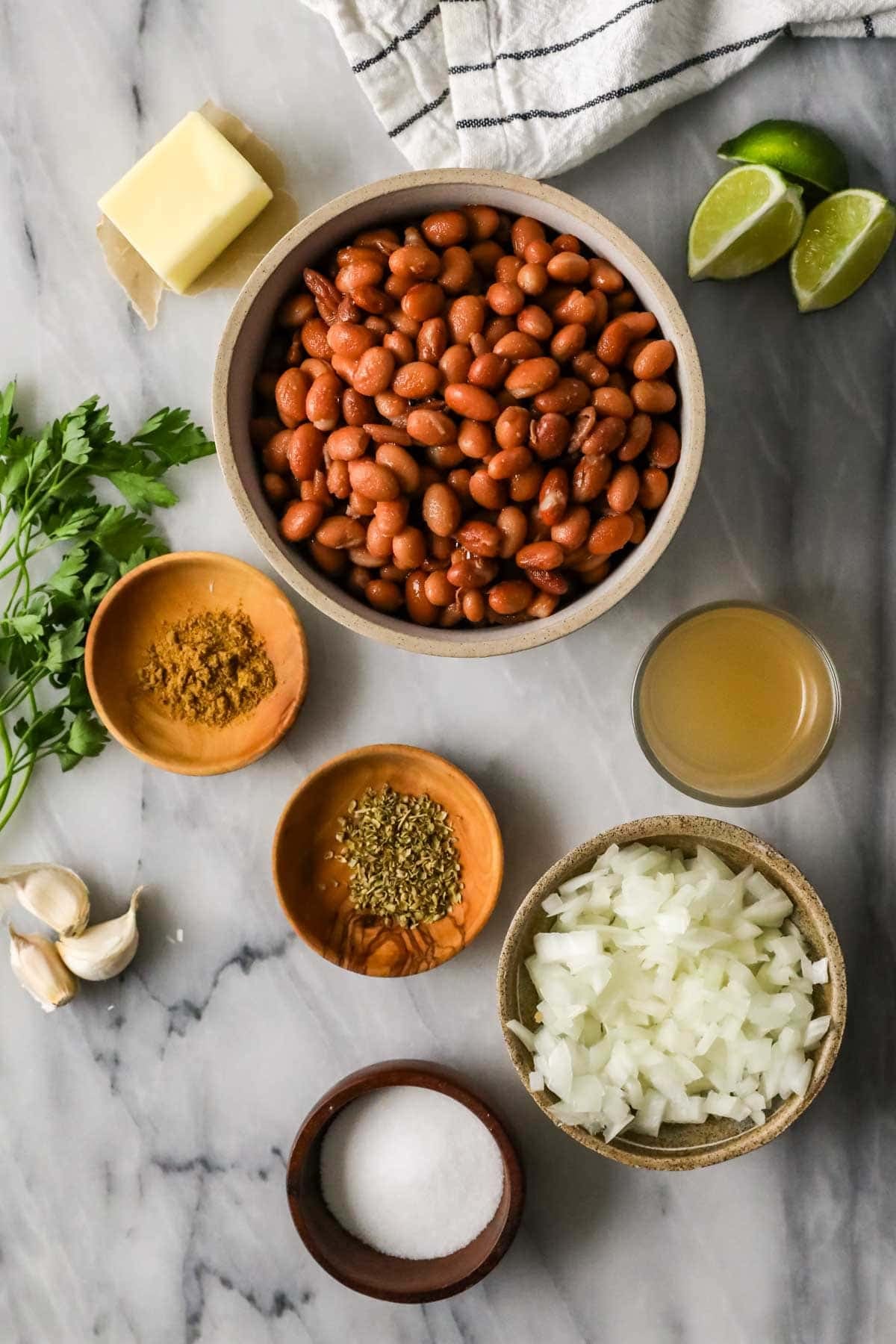 Overhead view of ingredients including pinto beans, onion, spices, and mre.